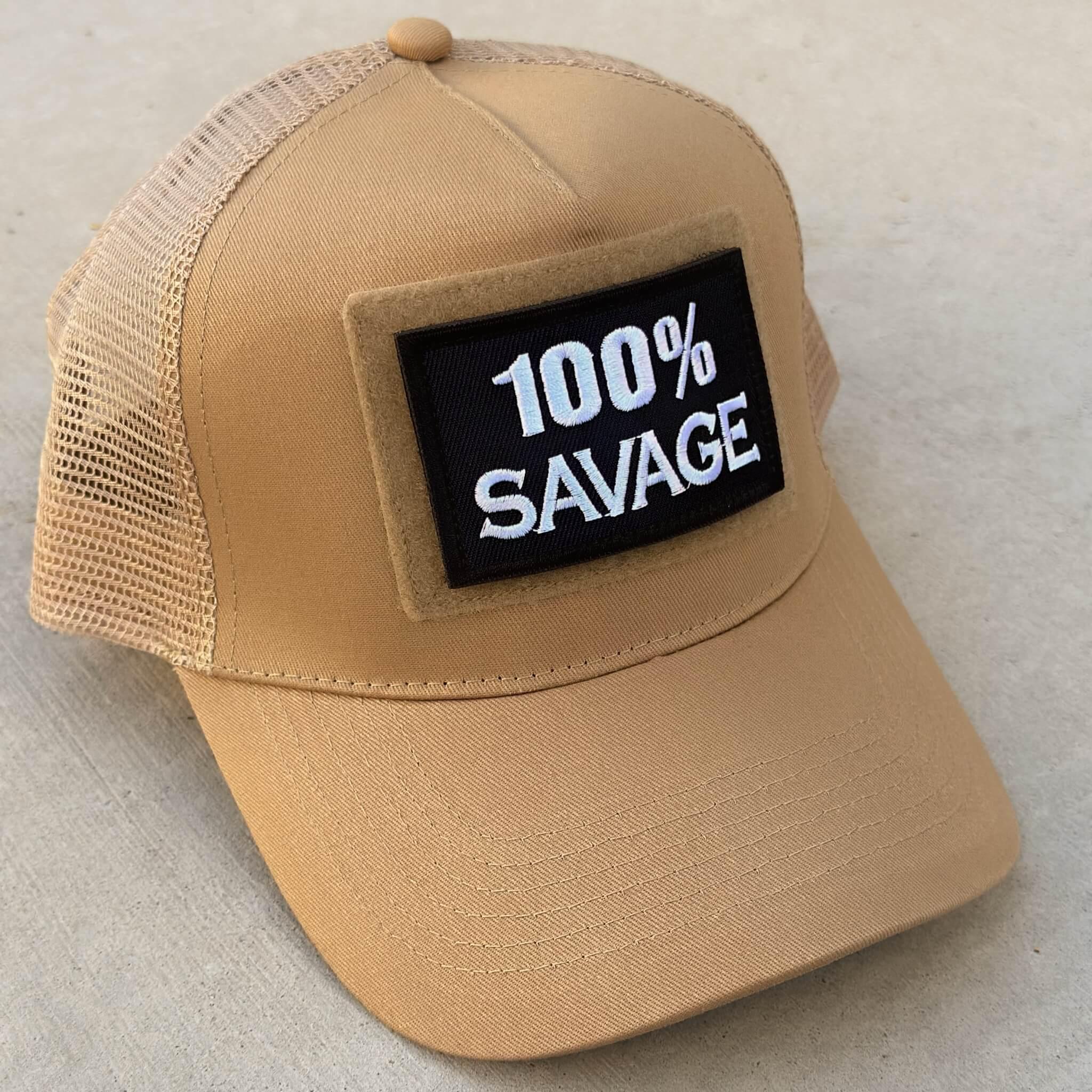 The trucker snapback cap in desert sand colors with 100% Savage patch attached