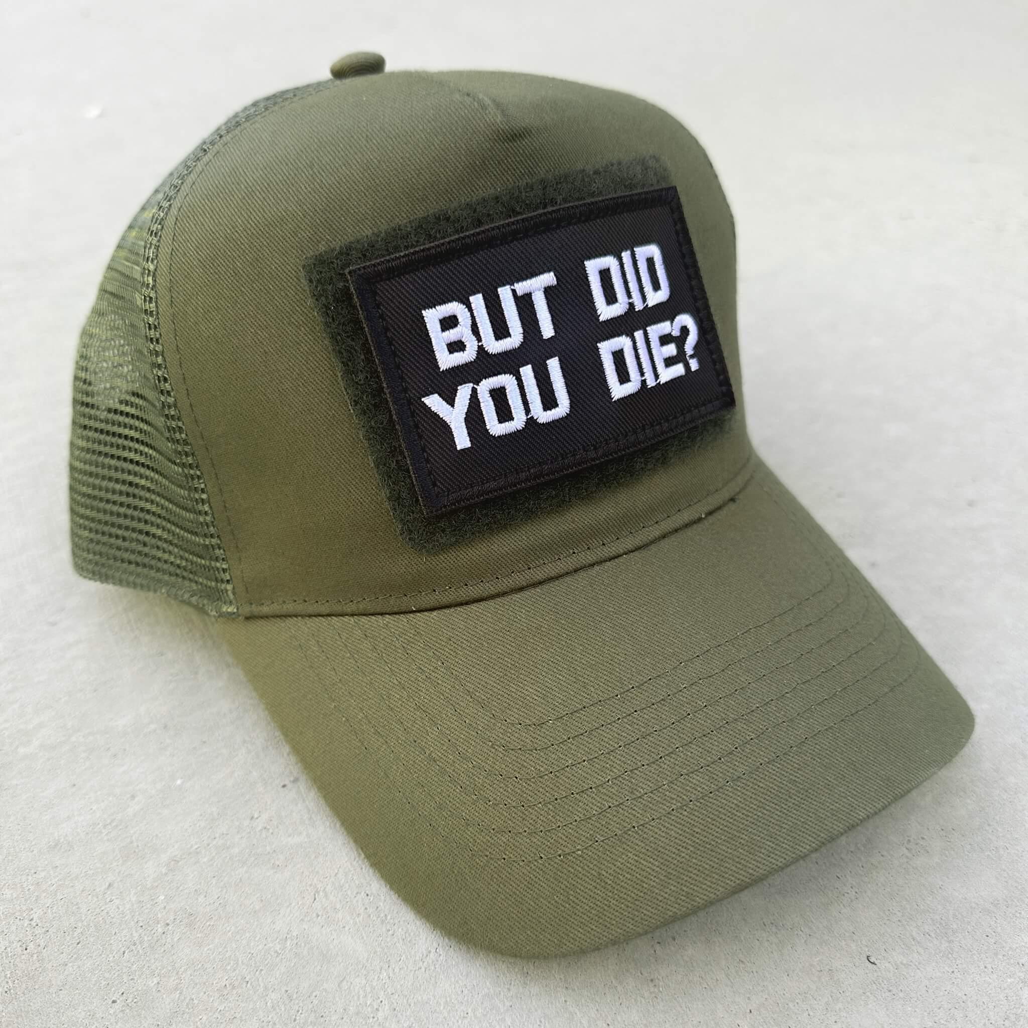 The trucker snapback cap in military green color with But Did You Die patch attached