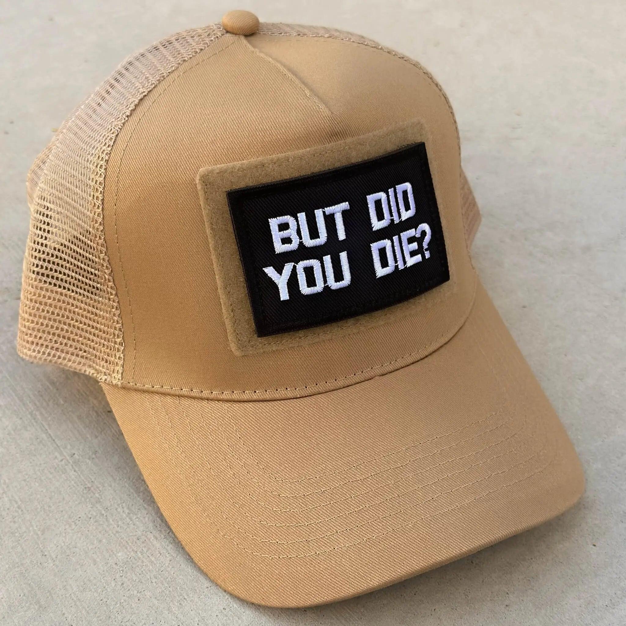 The trucker snapback cap in desert sand color with But Did You Die patch attached