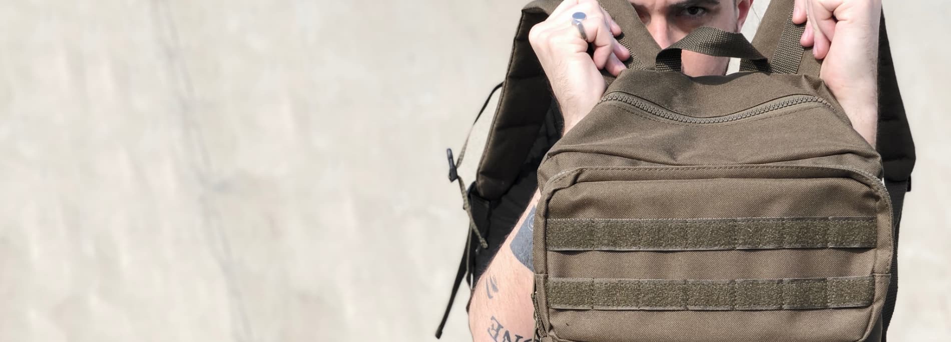 Model holding the Tactical Bag in military green